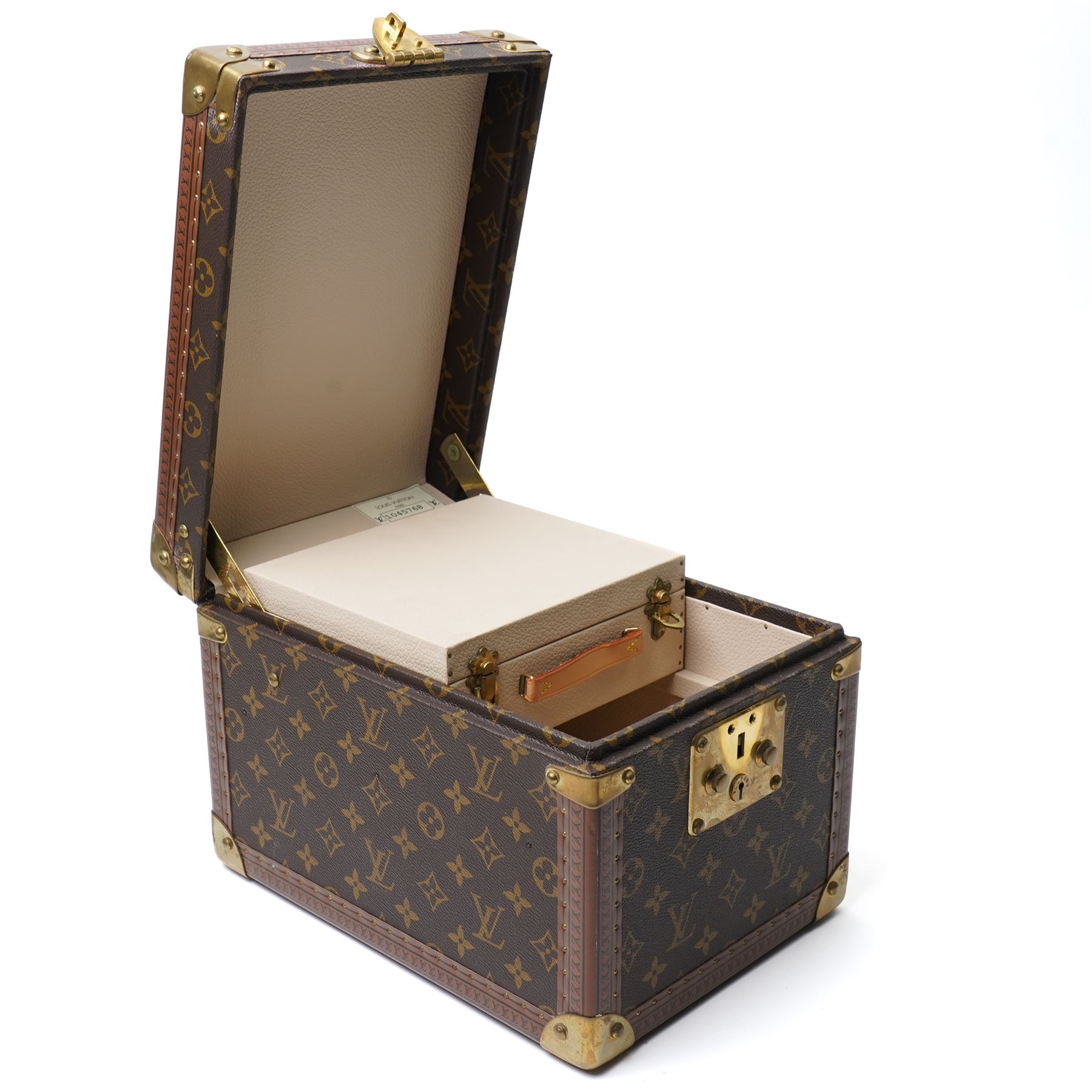 Late-20th century Louis Vuitton monogram Boîte Flacons vanity coffret, monogram canvas with lozine trim and brass mounts, single front brass lock stamped Louis Vuitton with key code 1247413, the interior fitted with leather flacon retaining loops and lift-out lidded tray with leather handle, label to interior printed Louis Vuitton Paris serial number 1045768, together with two keys stamped with matching serial numbers to the lock and luggage tag, circa late 1990s-early 2000s