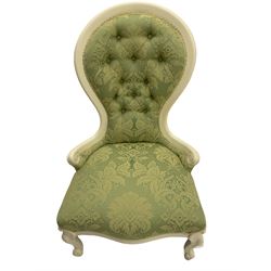 Victorian style white painted nursing chair, spoon buttoned back, upholstered in pale green foliate pattern fabric