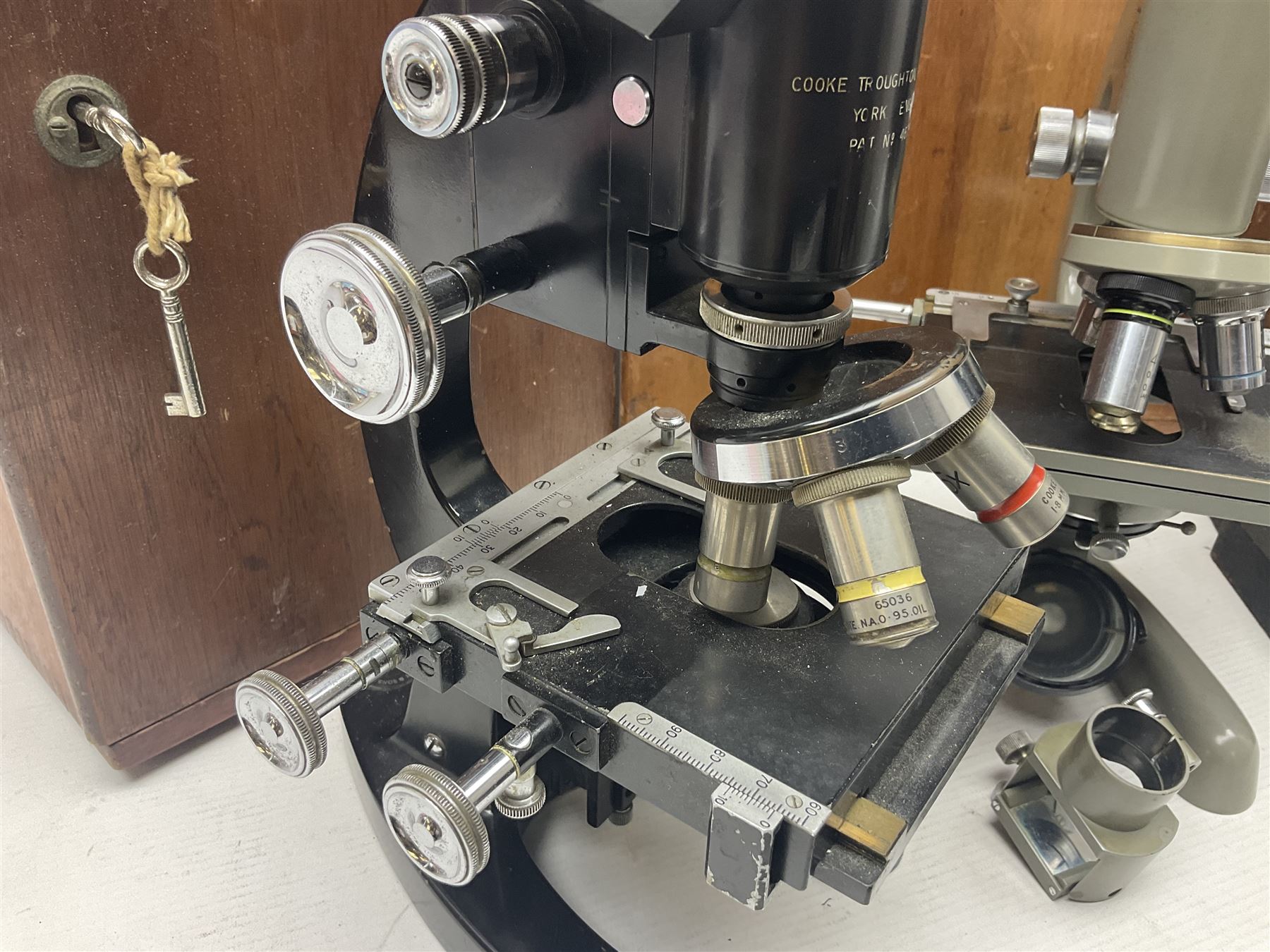 Four microscopes, including Cooke, Troughton & Simms no M467926, W Watson & Sons no 114758, W & J George & Beck Ltd no 36649 and one other 