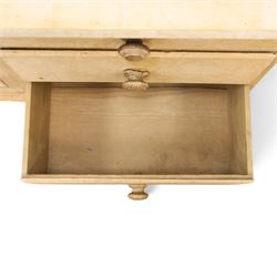 Victorian stripped pine dresser base with plate rack, the four-tier plate rack with supporting rails and hooks, the inverted-breakfront base fitted with seven assorted graduating drawers surrounding a recessed cupboard, on compressed bun feet with castors
