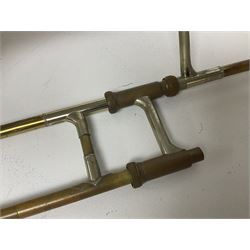 Three brass trombones comprising Elkhart Ind. USA 'CONN' model no.72H; Besson 'Concord'; and Selmer Distributed 'Lincoln'; two in carrying cases; and German B & M 'Champion' brass trumpet (4)