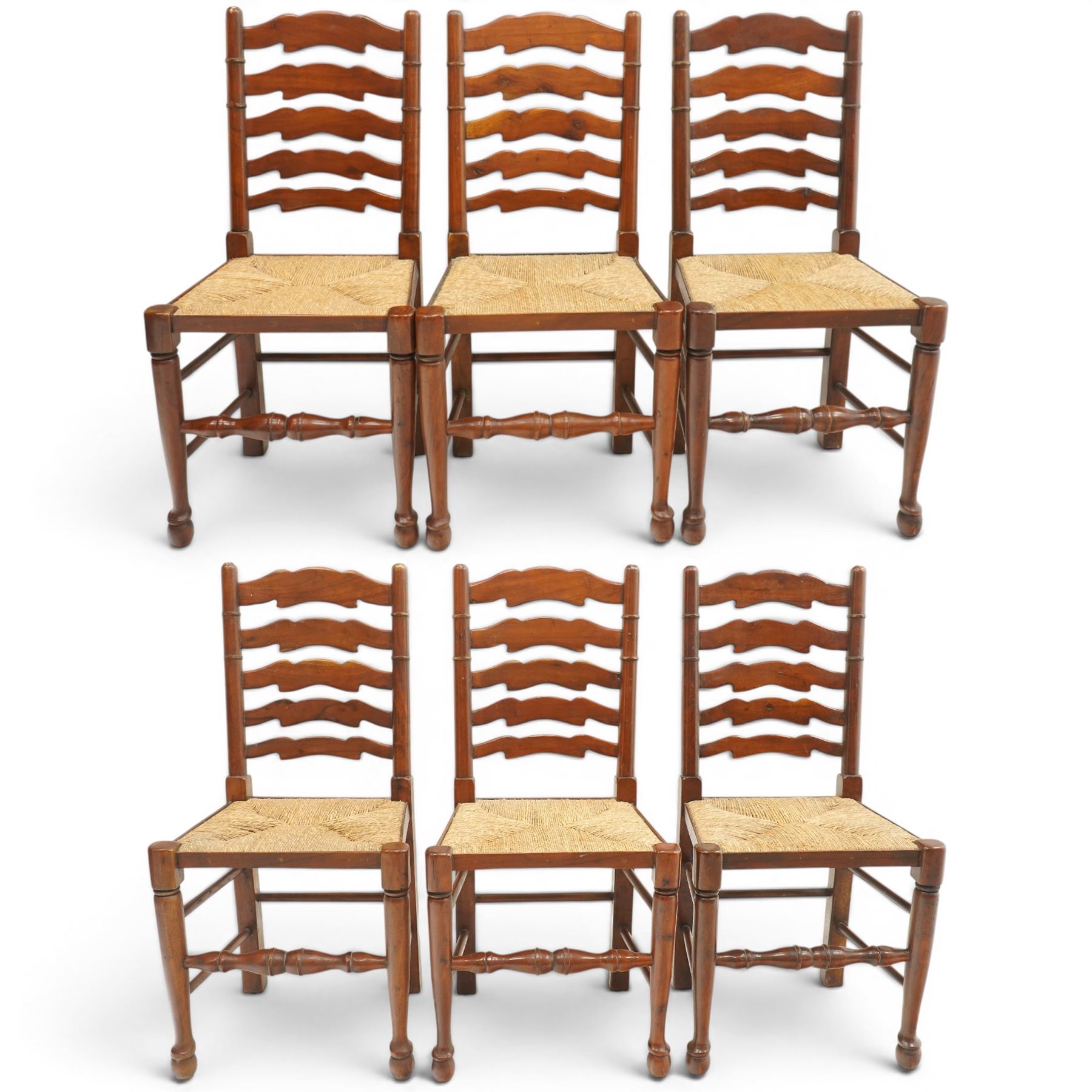 Set of six Lancashire country ladderback dining chairs with rush seats, raised on tapering supports with swell-turned stretcher