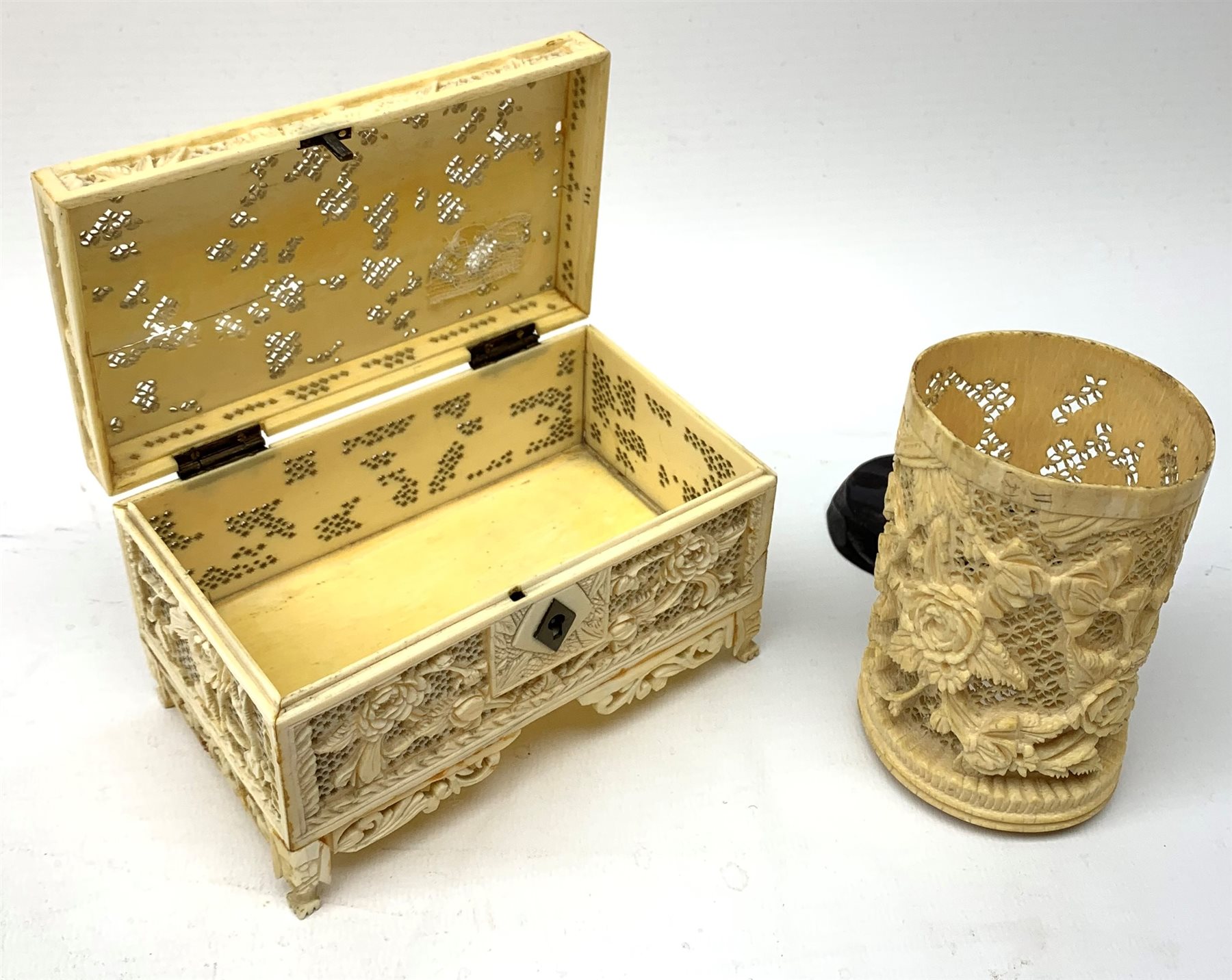 19th century Cantonese carved and pierced ivory small trinket box, L13.5cm and a similar cylindrical vase on hardwood stand H11cm (2)