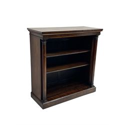 William IV rosewood open bookcase, rectangular top over hidden frieze drawer, three adjustable shelves flanked by turned pilaster columns carved with foliage, skirted base with chamfered edge