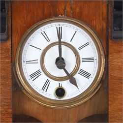 German miniature 8-day wall clock, in walnut case with gable pediment and finials, enamel dial with Roman numerals, minute track, steel spade hands and pendulum, H52cm