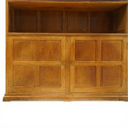 Beaverman - Yorkshire oak open bookcase, with adjustable shelves, panelled sides and lower cupboard doors, with carved beaver signature, by Colin Almack of Sutton near Thirsk