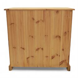 Contemporary pine storage cabinet, the rectangular top with rounded corners, over twin drawers and panelled cupboard doors, fitted with turned knob handles, plinth base