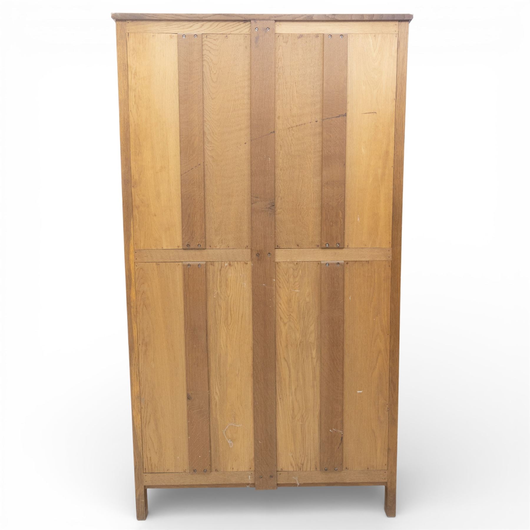 Acornman - oak adzed panelled double wardrobe, with wrought iron hinges and carved oak latch revealing a single clothes rail, with signature carved acorn to top right, by the workshop of Alan Grainger, Brandsby