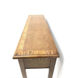 Contemporary oak, mahogany, and figured burr walnut narrow console table, moulded rectangular top with oak band and satinwood stringing, five cock beeded short drawers with turned handles, moulded and canted square supports 