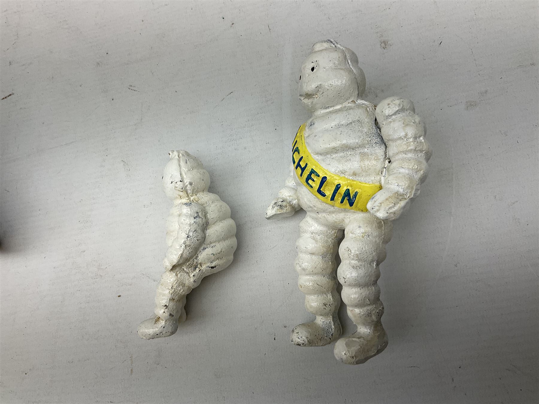 Cast iron figure of Michelin Man on motorbike modelled with smaller seated Michelin man in sidecar, H16cm