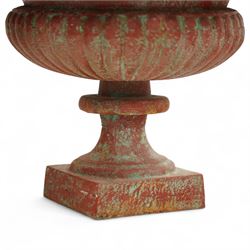 Pair of cast iron garden urns, each of flared form with crinkled edge rims and circular bodies, finished in aged red paint and raised on square bases