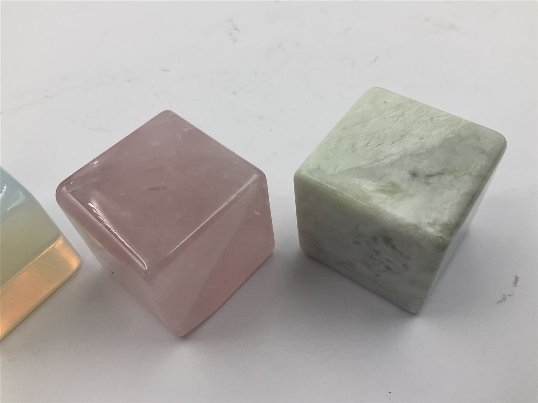 Ten cube mineral specimens, each cut and polished to highlight natural formations, including tiger eye, green aventurine, rose quartz, opalite, amethyst etc, H3cm 