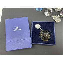 Swarovski Crystal paperweights, to include a globe with dove to the top, pyramid shapes etc, together with a large collection of boxes and stands  
