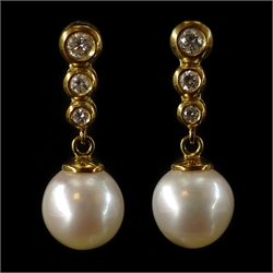  Pair of 18ct gold graduating three stone diamond and pearl pendant ear-rings, stamped 750  