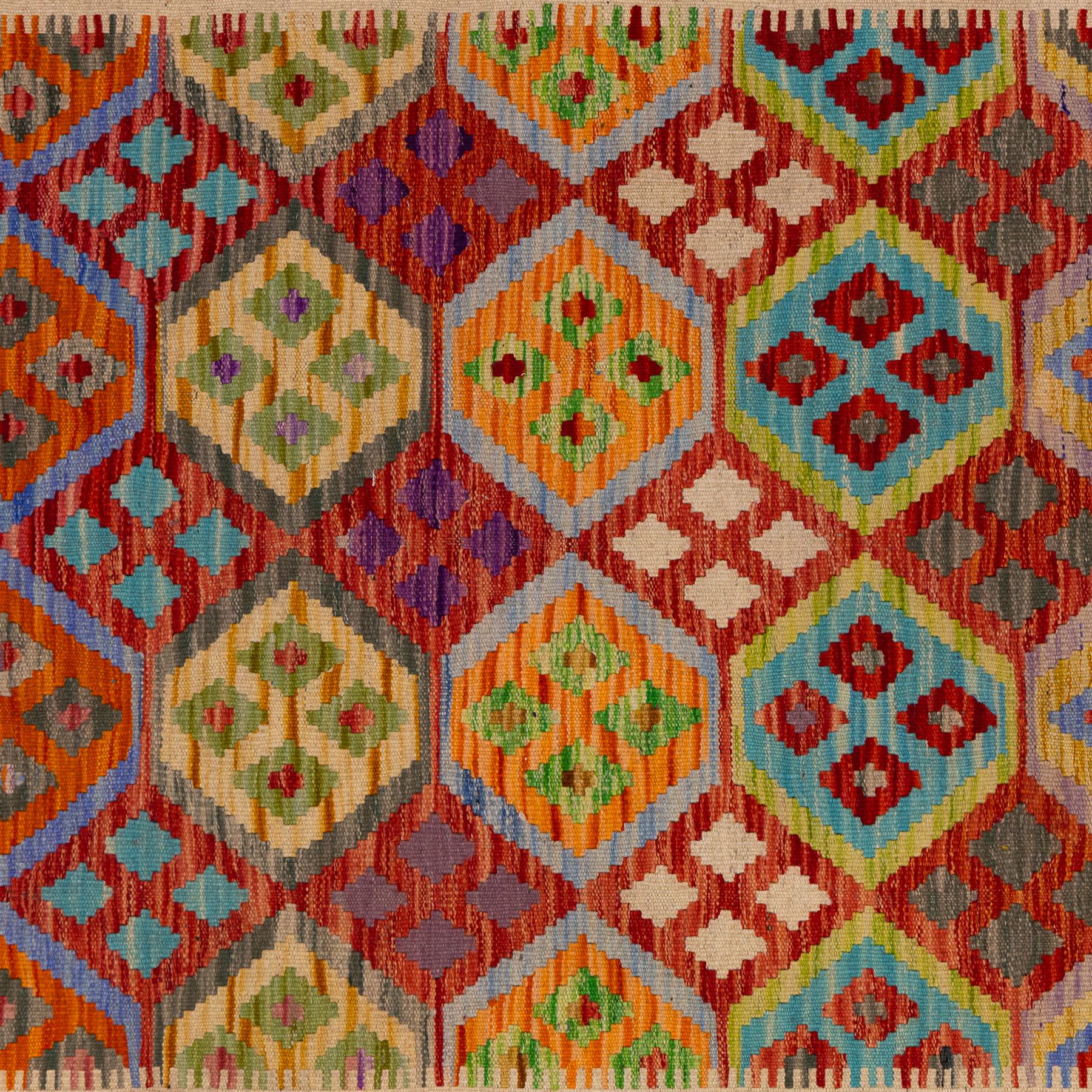 Turkish Anatolian flatweave kilim runner, ivory field decorated with rows of large polychrome lozenge medallions enclosing stylized geometric motifs with angular stepped borders, fringe ends 