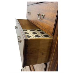 George III mahogany chest on chest, the upper section with two short over three long drawers with swan neck handles flanked by canted corners, inlaid with boxwood stringing below a dentil cornice. The lower section with three long drawers, supported on bracket feet 
