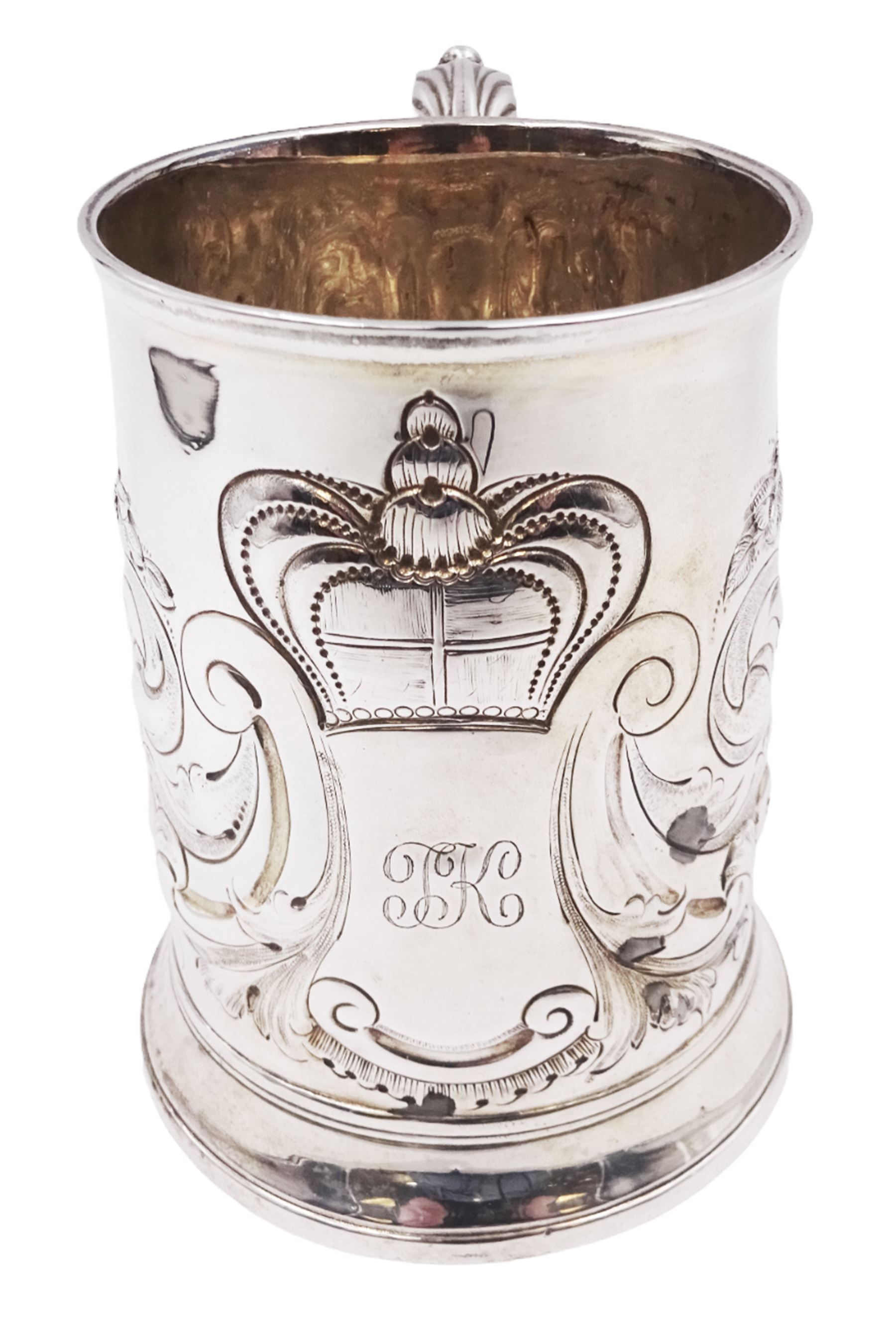 George III silver tankard, of slightly tapering cylindrical from, with chased and repousse crown above a monogrammed cartouche and floral, foliate and C scroll decoration, with acanthus capped C scroll handle, hallmarked WT, possibly William Turton, London 1774, H11.5cm