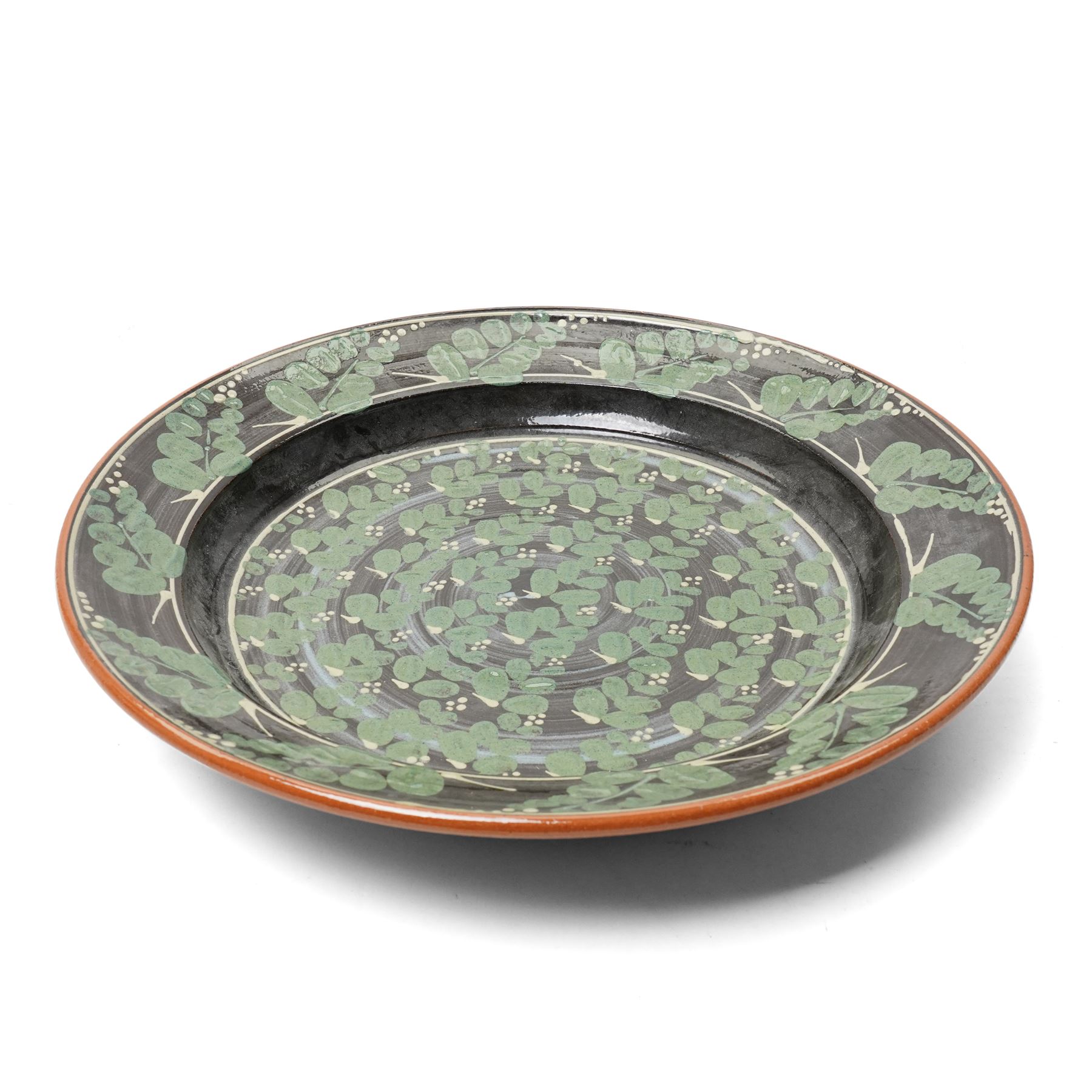 Richard Phethean (1953-): Slipware charger, decorated with green foliage on a black ground, D40cm 