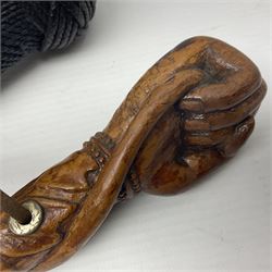 19th century wooden walking stick, the handle carved as a snake within a clenched fist, the cane carved with foliate and cross hatched decoration, with a metal spike to base, together with a turned wooden walking stick, with lacquered rope nautical knot handle, tallest L96.5cm