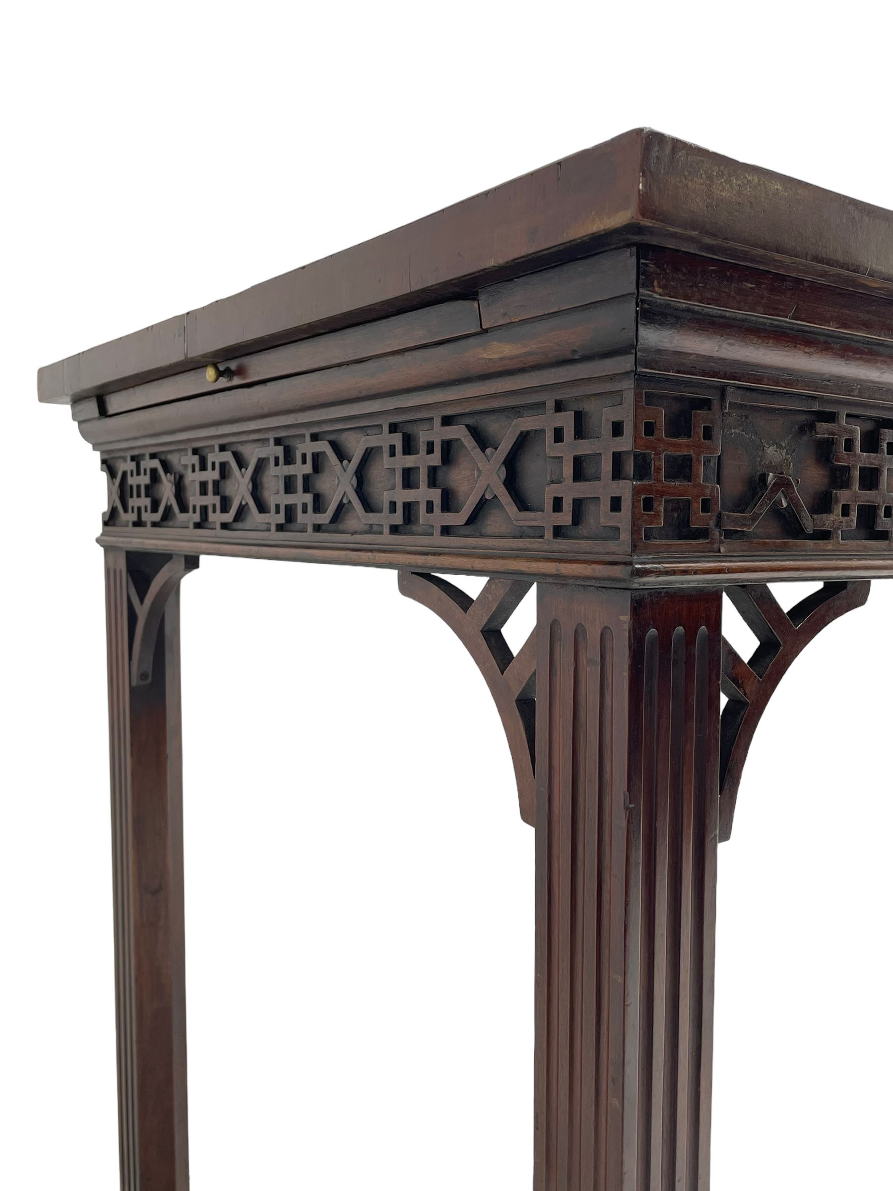 In the manner of Thomas Chippendale - early 19th century mahogany serving table, rectangular crossbanded top with boxwood stringing, the frieze with upper moulding over applied geometric fretwork, the left-hand side fitted with slide, on fluted square supports with inner chamfer 