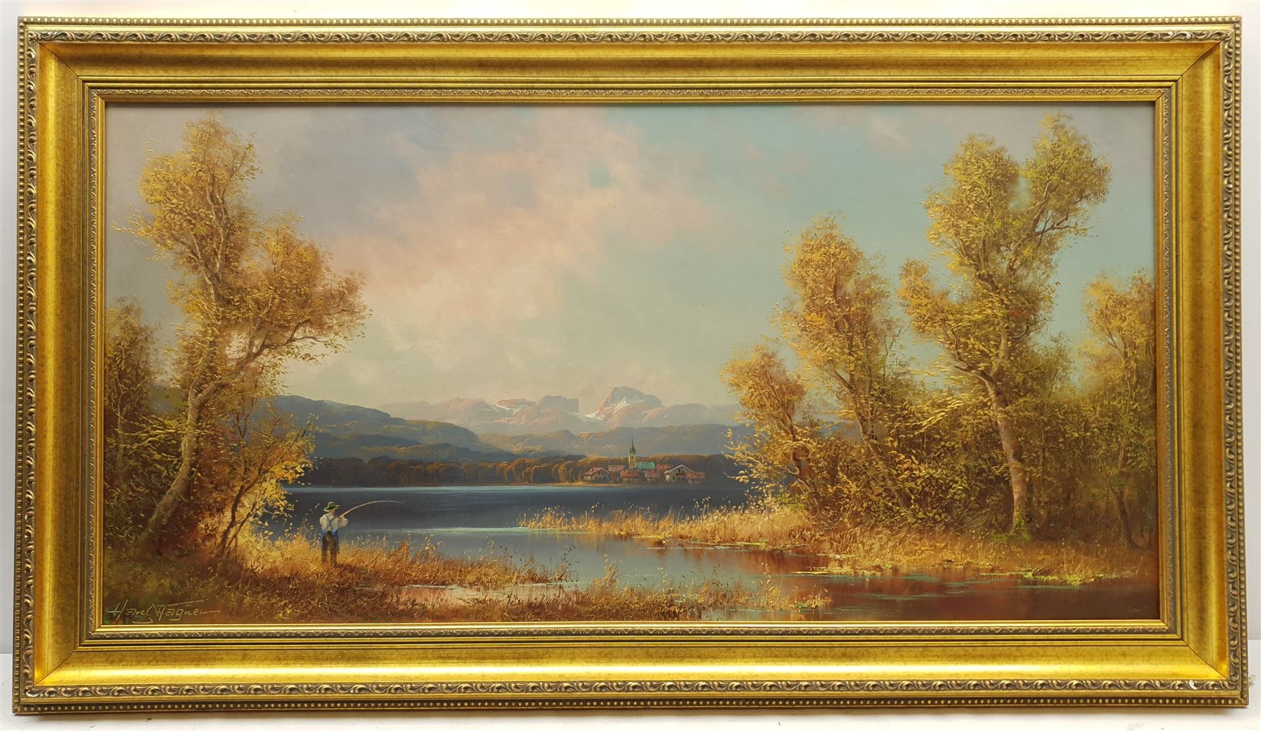 Hans Wagner (Continental 20th century): Fishing in a Mountainous Lake Landscape, oil on canvas signed 49cm x 100cm; Continental School (Early 20th century): Mountain Landscape, oil on canvas indistinctly signed 45cm x 56cm (a/f) in heavy gilt frame (2)
