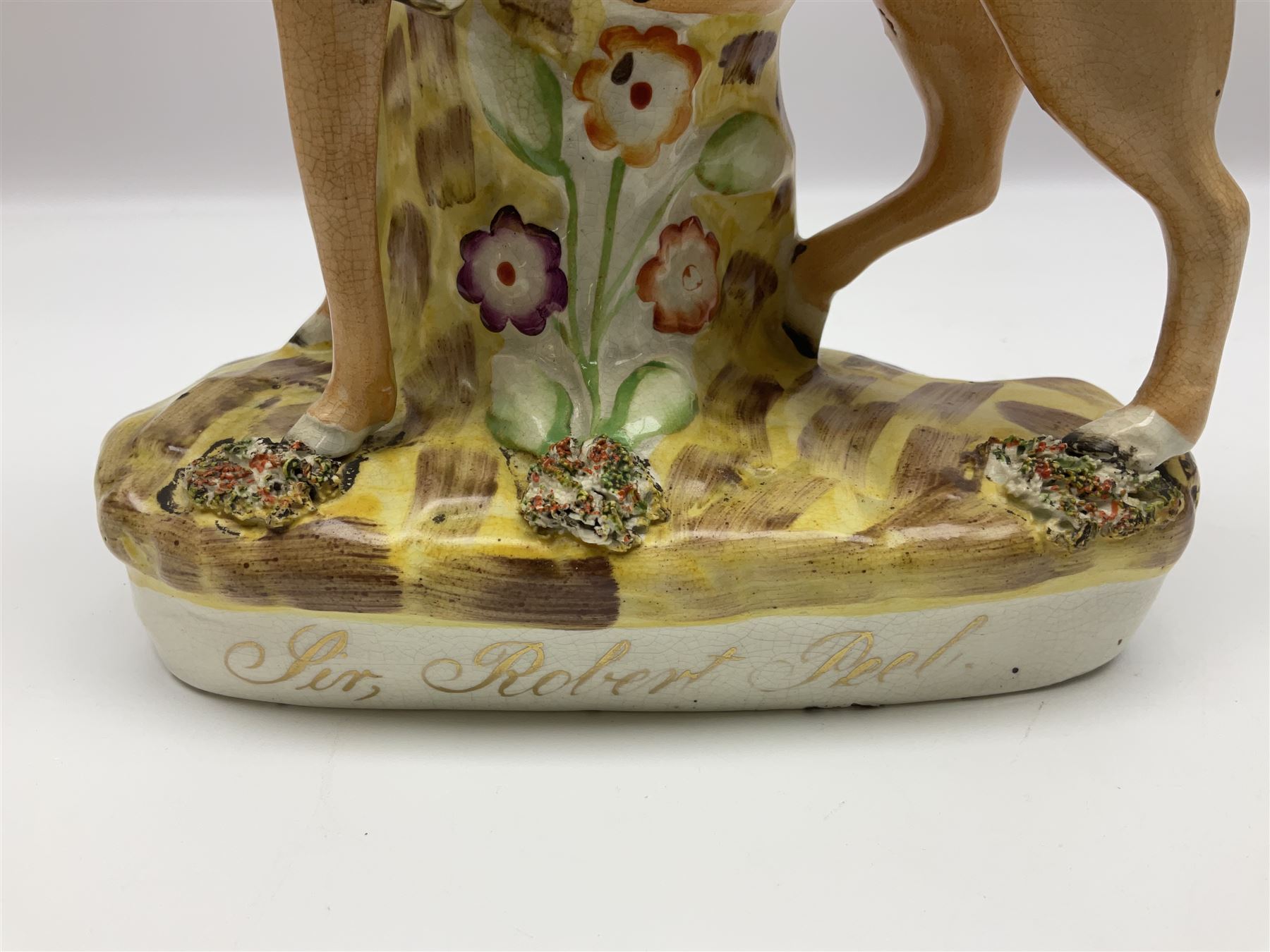 19th century Staffordshire figure of Robert Peel, titled 'Sir Robert Peel', modelled on horseback, atop an oval plinth base featuring a naturalistic and floral design, H30cm 