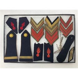 Over thirty items of French Sapeur Pompiers (Fire Service) cloth insignia and buttons c1930s/40s; in small glazed display case