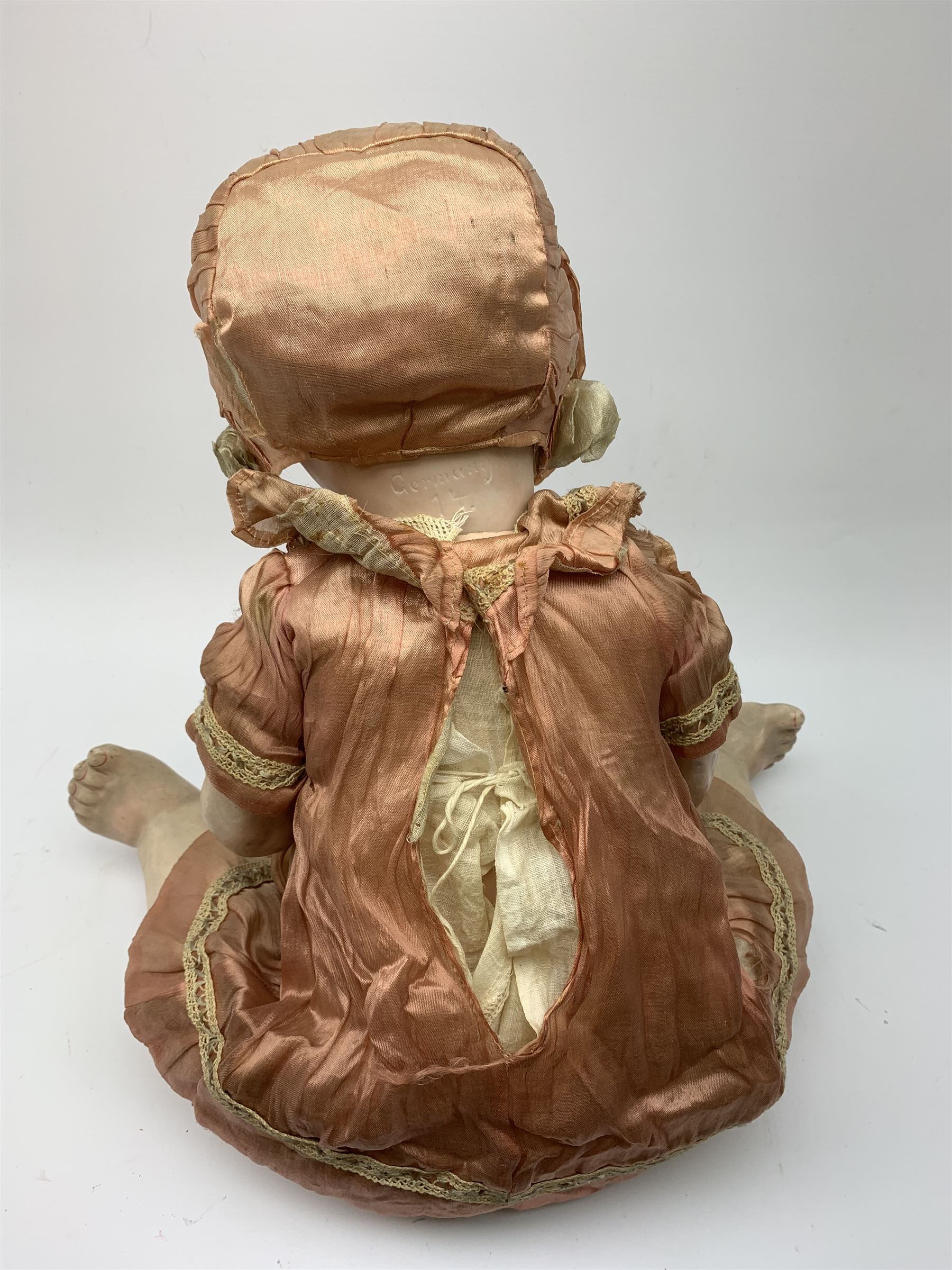 German bisque head doll with applied hair, sleeping eyes and open mouth with teeth and fixed tongue, on composition body with jointed limbs, marked 'P.M. 914 Germany 14' H65cm