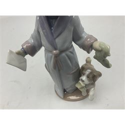 Lladro figure, Dear Santa, modelled as young boy in dressing gown and Santa hat with dog, sculpted by Antonio Ramos, with original box, no 6166, year issued 1995, year retired 1999, H21cm
