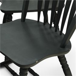 Contemporary country style pine and painted dining table and four chairs, the rectangular plank top with exposed knots and pegged detailing over black painted turned legs, the four Windsor style chairs with shaped seats, spindle splats and turned stretchers, also painted black