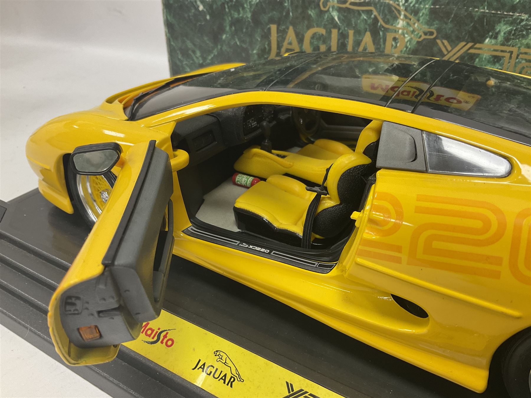Two Maisto 1:12 scale Jaguar XJ220 ‘Racing’ cars in yellow, both on plinths in original boxes 