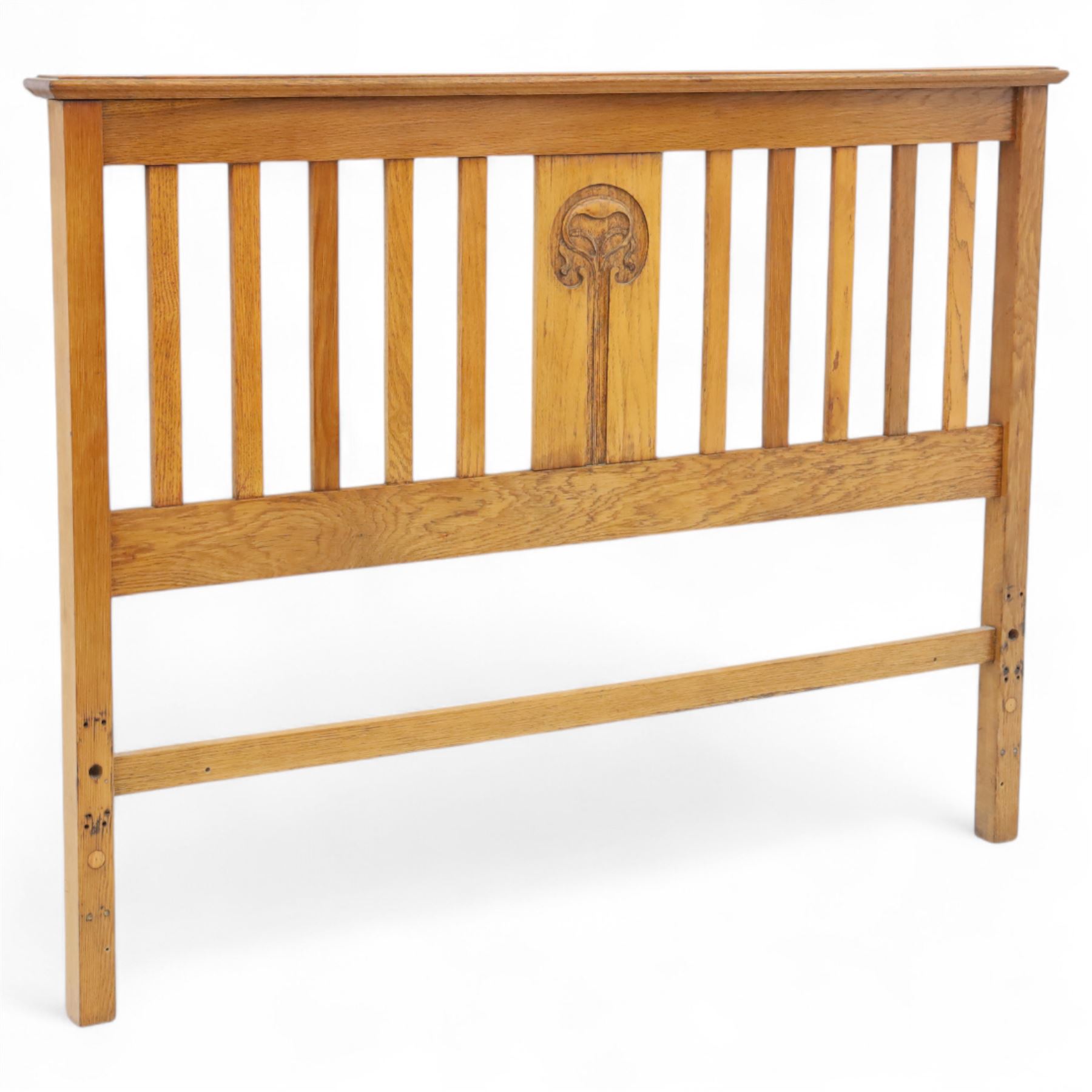 Art Nouveau oak double bed headboard, rectangular form with vertical slats centred by a carved stylised floral roundel