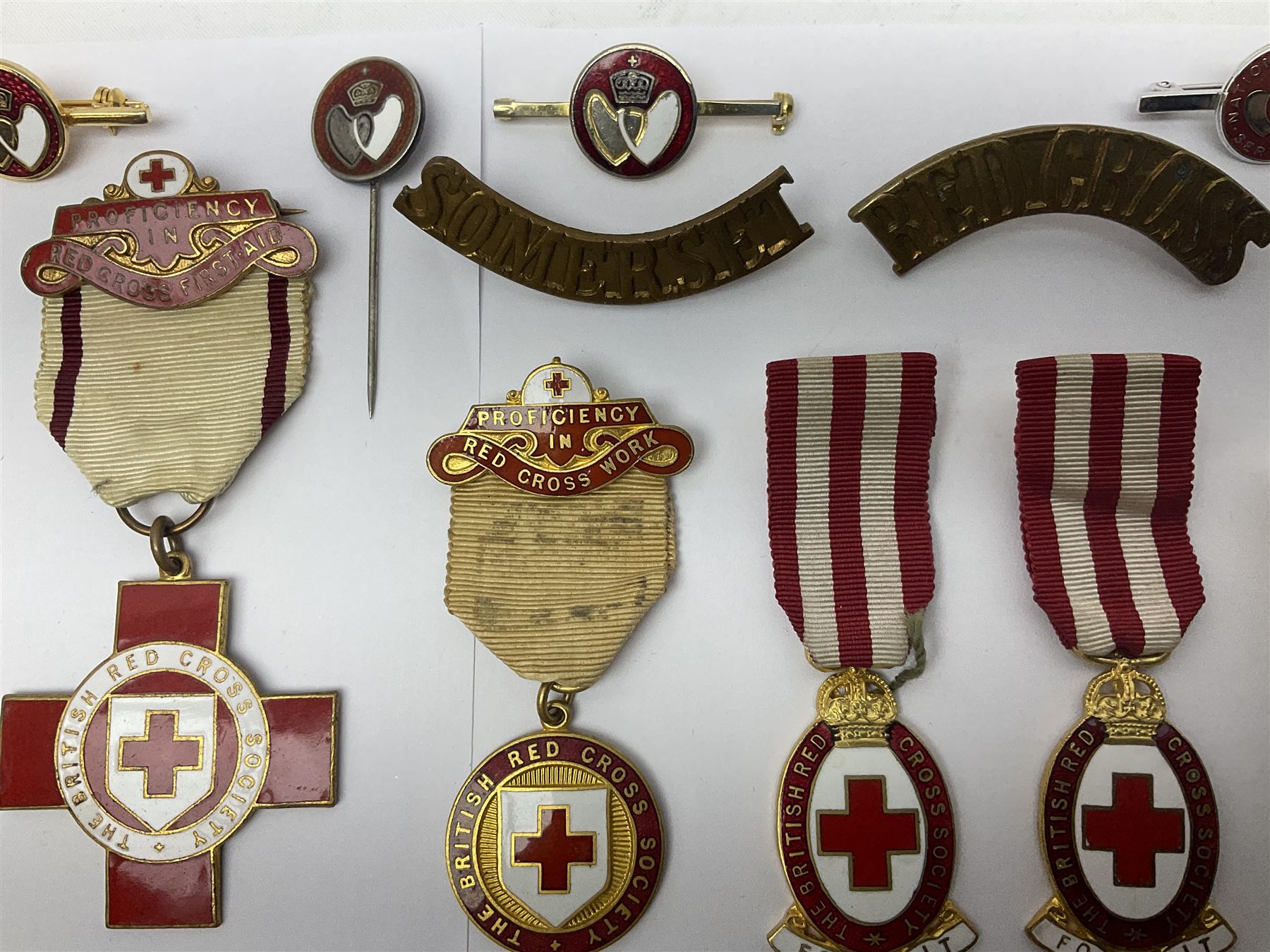 Collection of St John Ambulance enamel and metal badges, together with Red Cross medals and badges