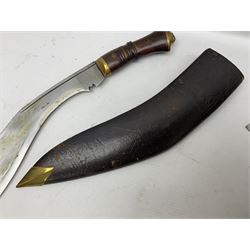 Early 20th century Indian sword stick, the 61.5cm steel blade with punched decoration to one side; horn handle with brass lion mask pommel and ferrule; ebonised shaft with carved bands L92cm overall; and a kukri with curving blade, hardwood and brass grip in leather covered scabbard with two skinning knives (2)