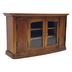 Contemporary cherry wood corner TV unit, canted top over central glazed double doors opening to shelves for media storage, flanked by side storage compartments, on a plinth base