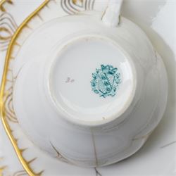 Early 20th century Sarreguemines tea wares, decorated with peacock feathers in gilt, comprising six teacups, eight saucers and eight side plates