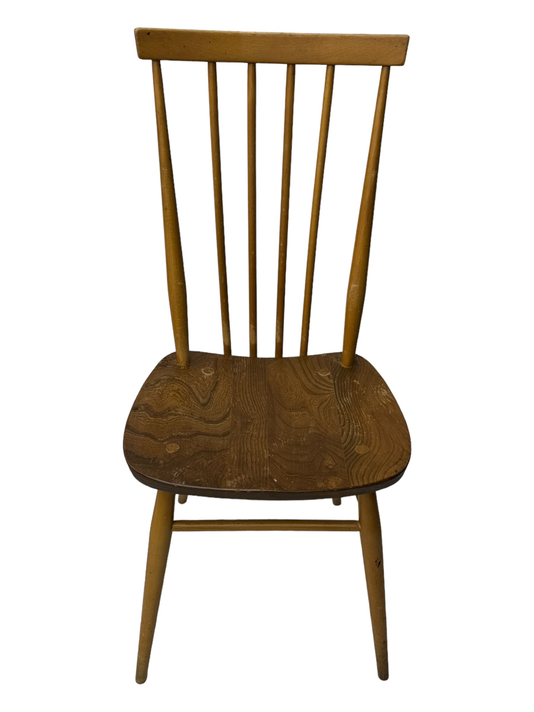 Ercol - pair of mid-20th century highback 'Windsor' chairs, curved top rail over six vertical spindles and shaped seat, on tapering cylindrical supports with stretchers