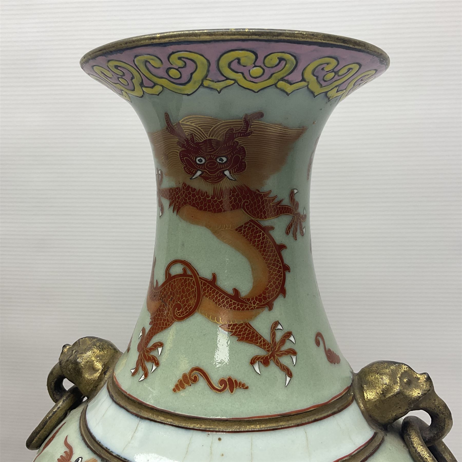 Pair of early 20th century Chinese vases decorated with dragons chasing a flaming pearl, with a gilt border of butterflies and floral sprigs, with Elephant head handles, H44cm 