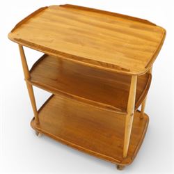 Ercol - elm tea trolley, Model 458. Rectangular three-tier form with shaped gallery edges, supported on turned upright supports, raised on castors