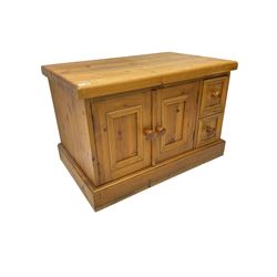 Rustic pine pot warmer cupboard, fitted with two panelled cupboard doors and two small drawers