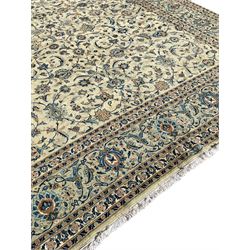 Persian Kashan carpet, light sage green ground, the field decorated all-over with interlaced foliate and plant motifs, repeating scrolled border with stylised flower head motifs