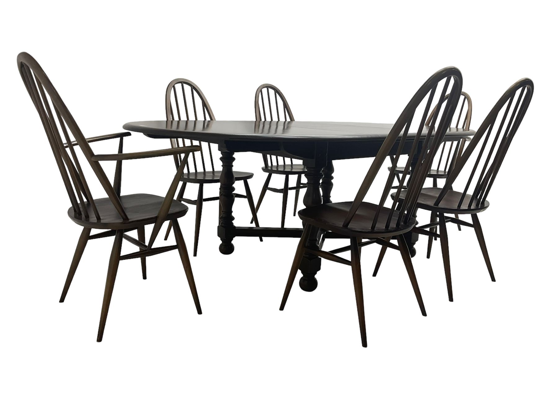 Ercol - 'Old Colonial' 705 elm extending dining table, oval top with hidden leaf, raised on turned supports united by X-stretcher (W163cm D108cm H72cm); and Ercol - set six  (4+2) dark elm 'Quaker Back Windsor Dining Chairs', hoop and stick backs 