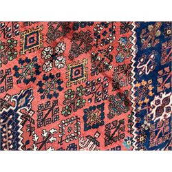 Persian Joshgan red ground rug, the medallion, field and spandrels decorated with clusters of Pitrak and tree of life motifs, the border with repeating design decorated with stylised plant motifs, within guard stripes