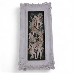 Composite plaque decorated in relief with putti amongst flowering roses, together with similar framed example and two others, framed H56cm, W28cm