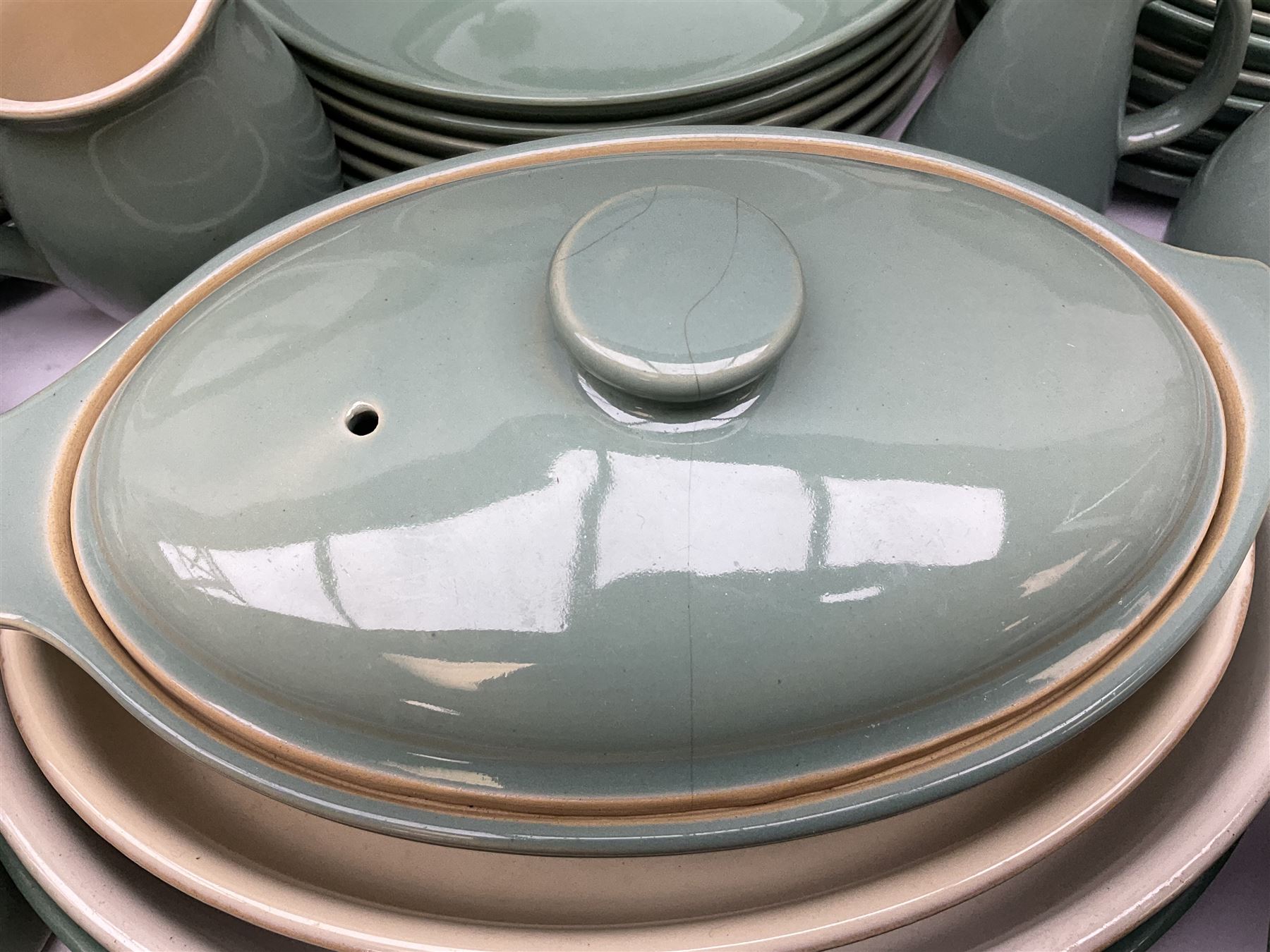 Denby Manor Green pattern part tea and dinner service, to include seven dinner plates, thirteen side plates, ten dessert plates, two oval dishes of various sizes, four cups and saucers, seven bowls with covers, two teapots etc (74)  