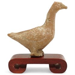 Chinese Tang Dynasty small carved terracotta figure of a goose, c.618AD-907AD, on scrolled red hardwood stand, H8cm 
