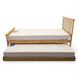 Contemporary light oak trundle bed, slatted headboard and footboard,  incorporating pull-o...