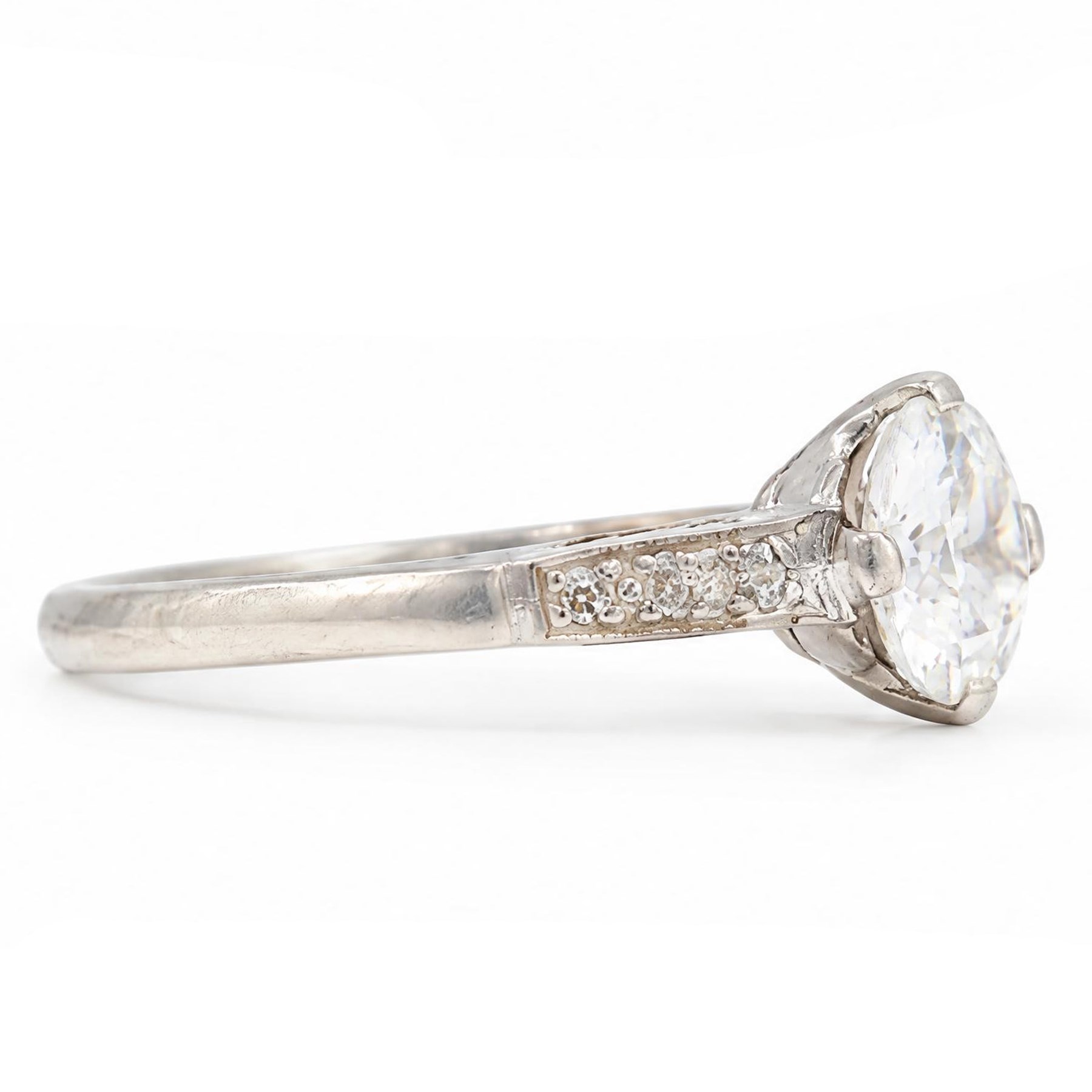 Early 20th century platinum diamond ring, four claw set with a single old cut diamond of approx 0.90 carat and diamond set shoulders, stamped Plat, inscribed with initials and dated 7.6.28