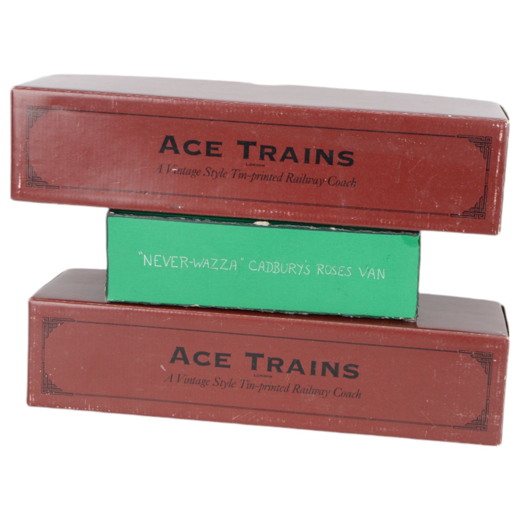 Three 0 gauge coaches, comprising an ACE Trains tin-printed All Third coach in LMS maroon livery, an ACE Trains tin-printed EMU MET 1st coach and a 'neverwazza' goods wagon, painted in Cadbury's Roses livery