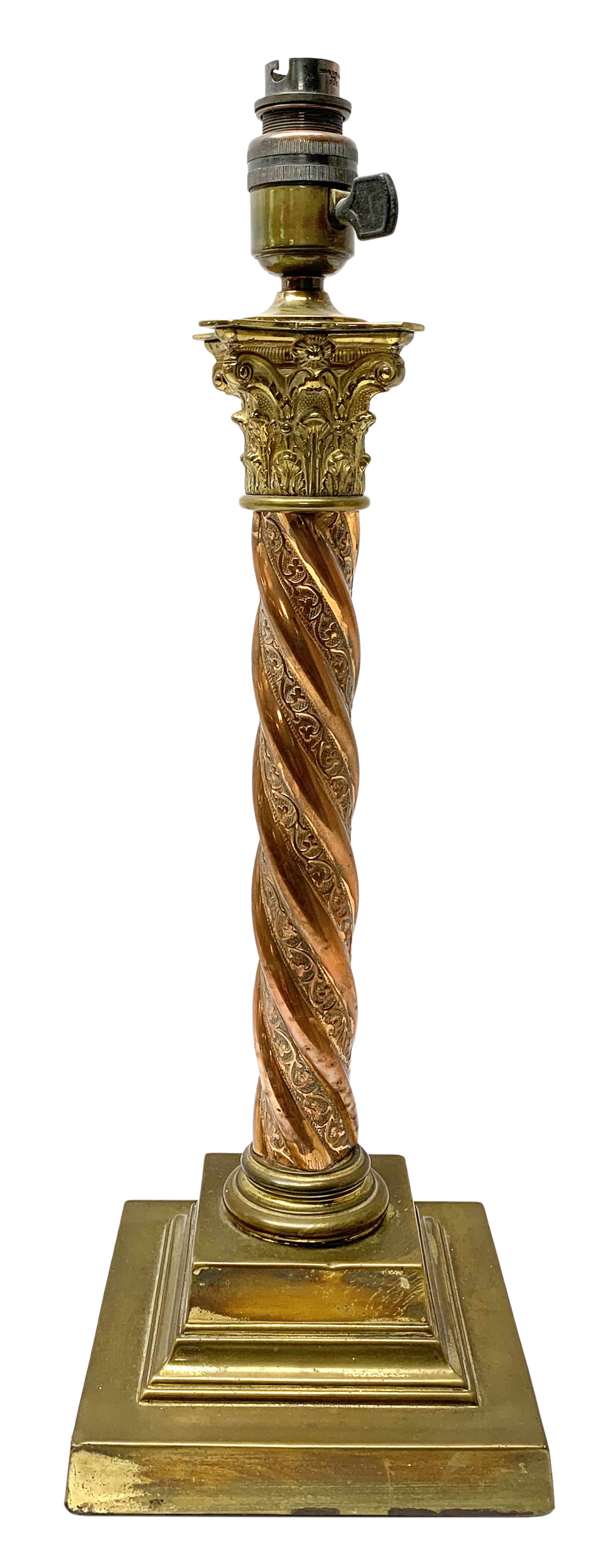 Early 20th century brass and copper Corinthian column table lamp, the square stepped brass base leading to a spiral twist copper column and brass Corinthian capital, H44.5cm 